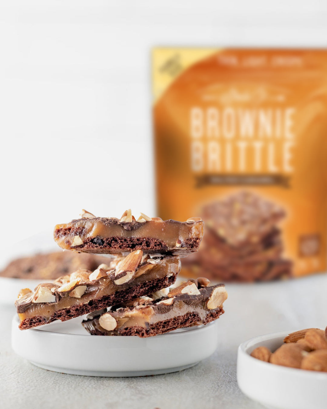 Brownie Brittle Almond Toffee with a bag of salted caramel at the back