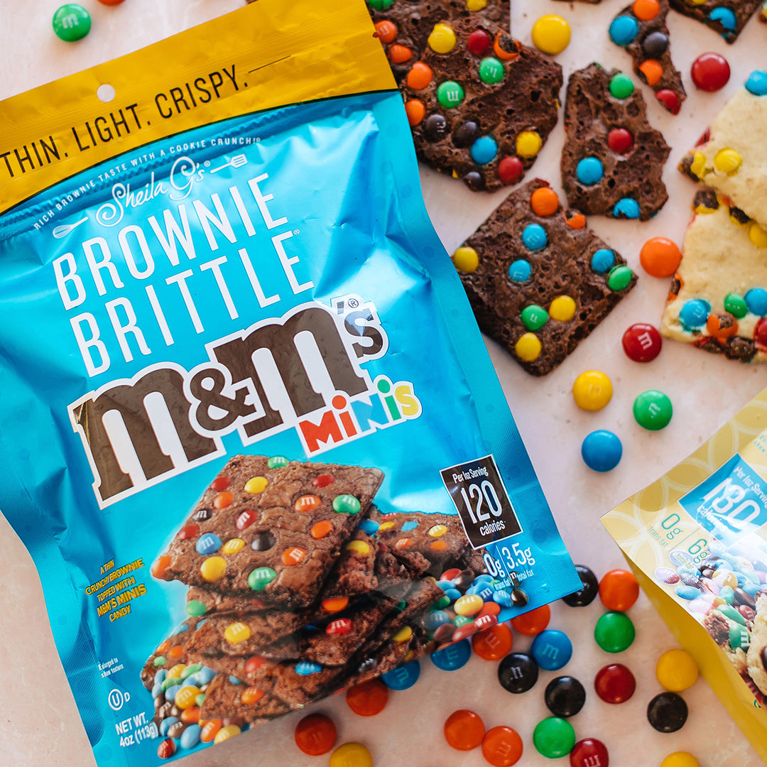 M&M'S® Minis Brownie Brittle with M&M spread around on the table
